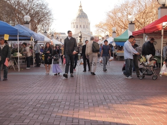 Tall man walking through the Heart of the City Farmers' Market in Civic Center SF (photo)