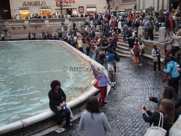 Tossing a coin into the Trevi Fountain