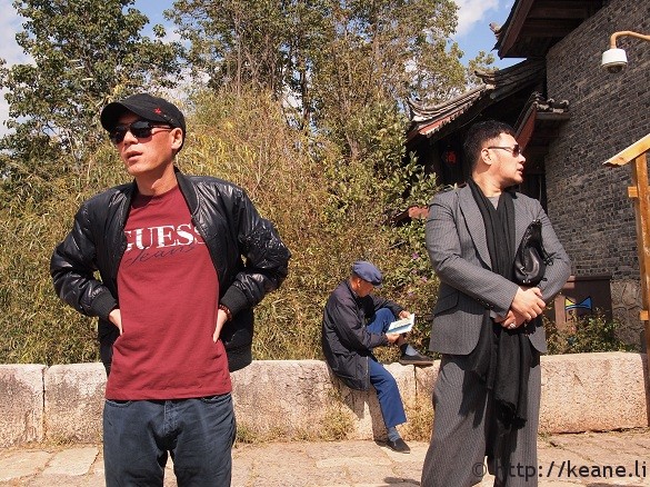 Three guys dressed three different ways on Qinglong Bridge in Shu He