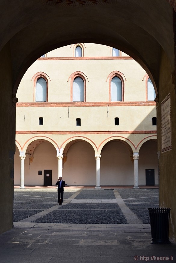 Man on Phone in Courtyard in Castello Sforzesco in Milan